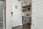 Cubby behind entry door with additional storage